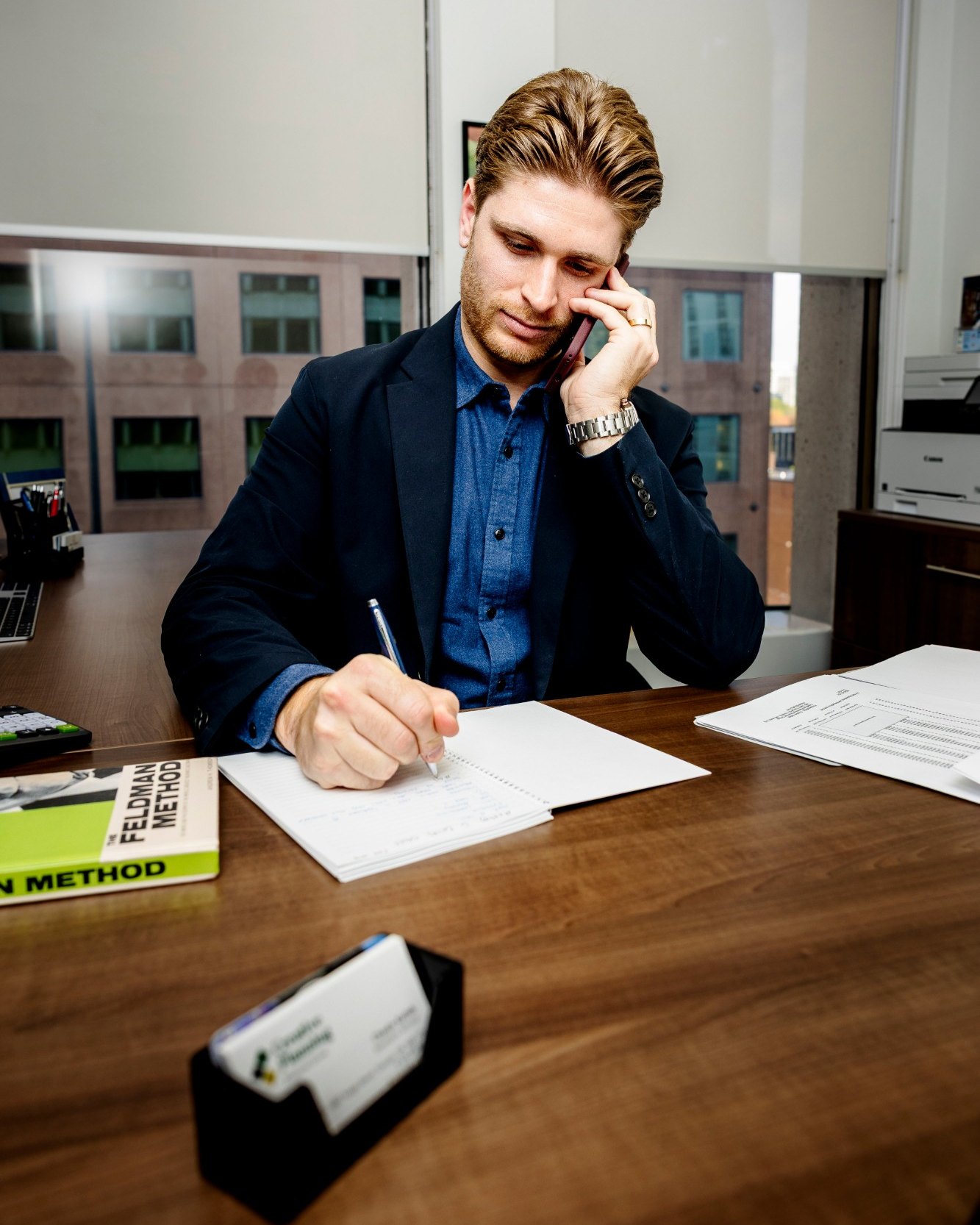 Chase Kalish on a phone call at his desk